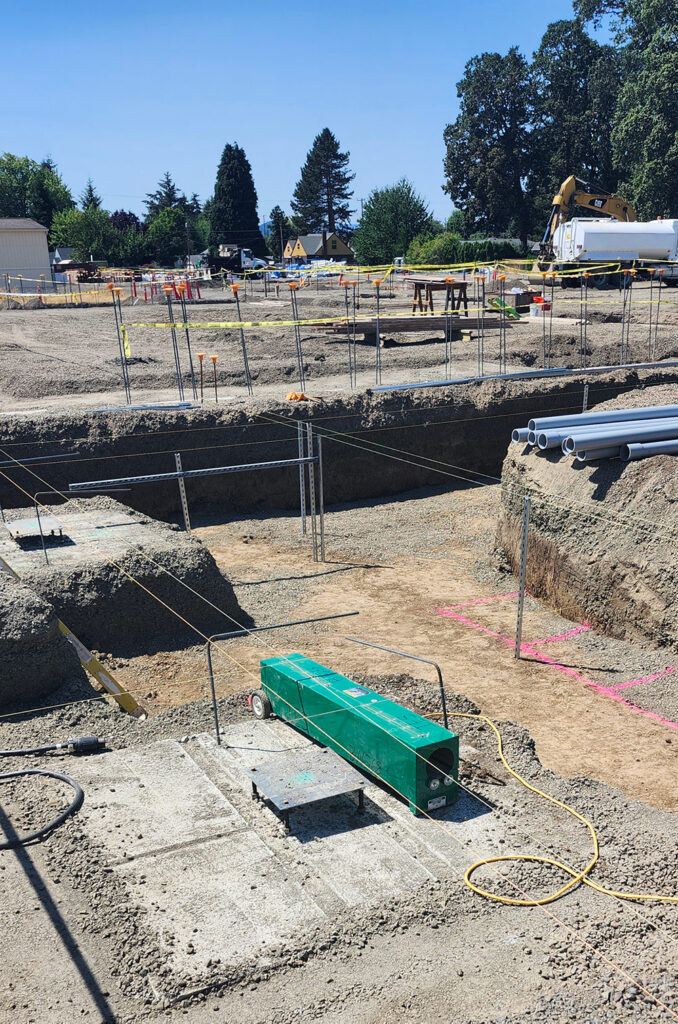 Electricians installing underground conduit.