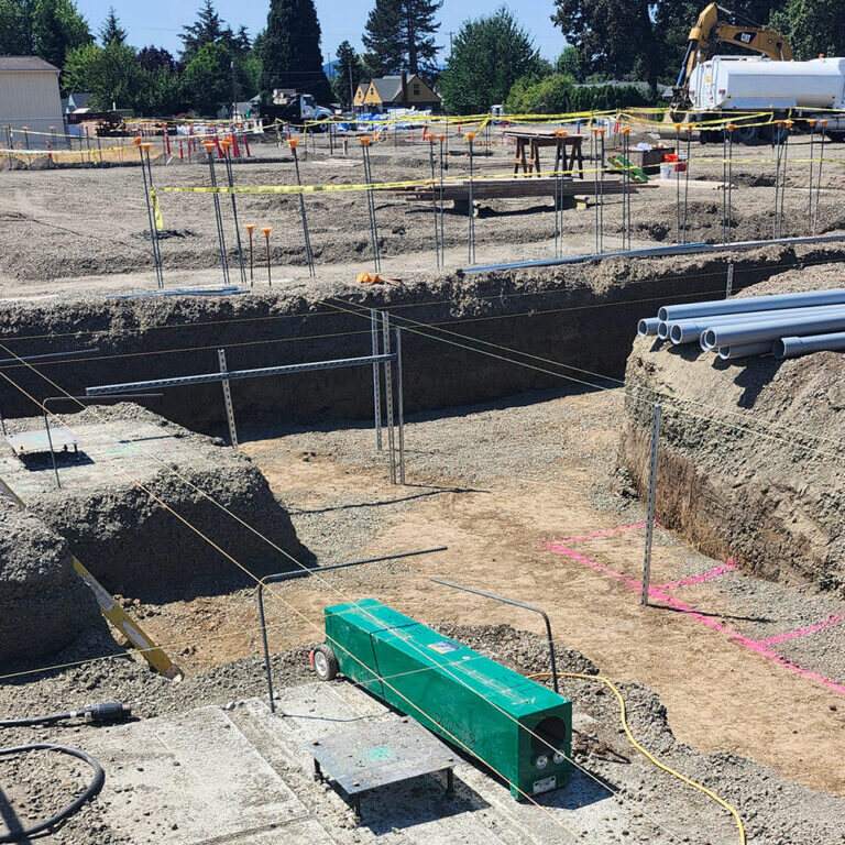 Electricians installing underground conduit.